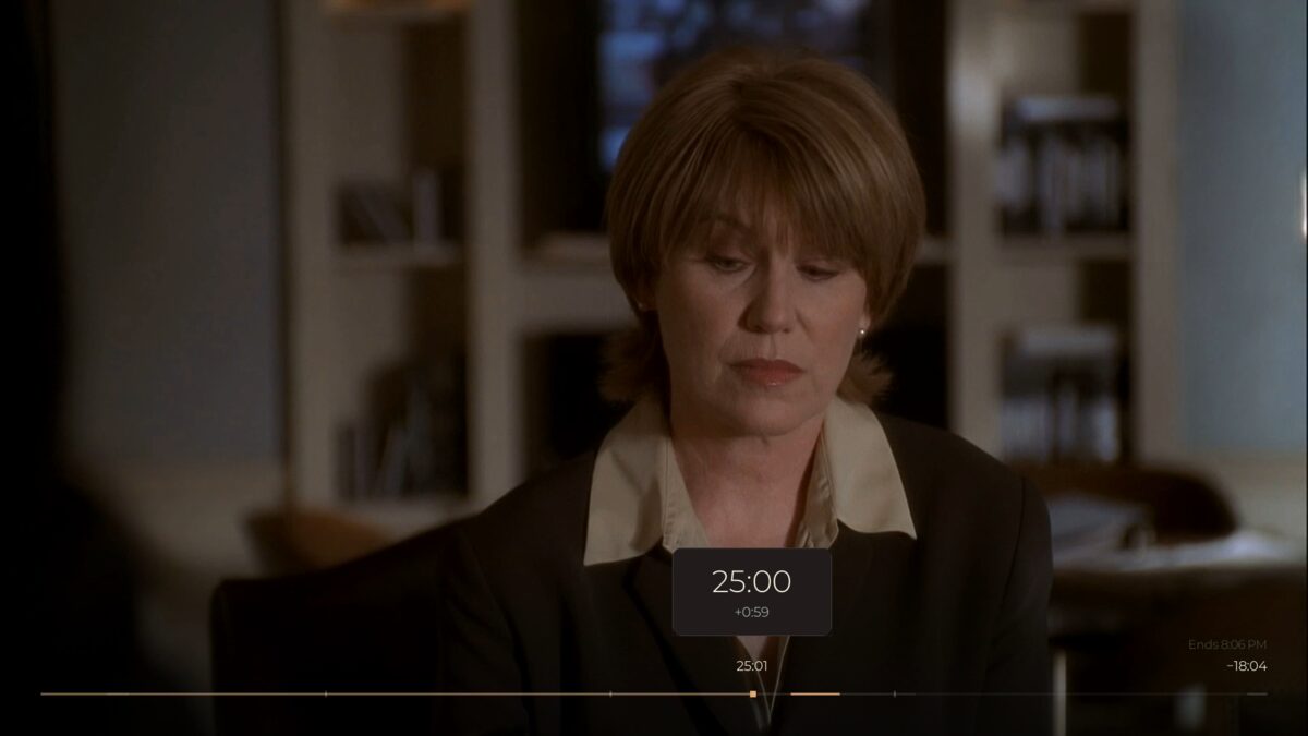 Mid-seek: a destination plate over the film showing the target time and a signed distance from where the journey started, with the ends-at clock updating in the corner.